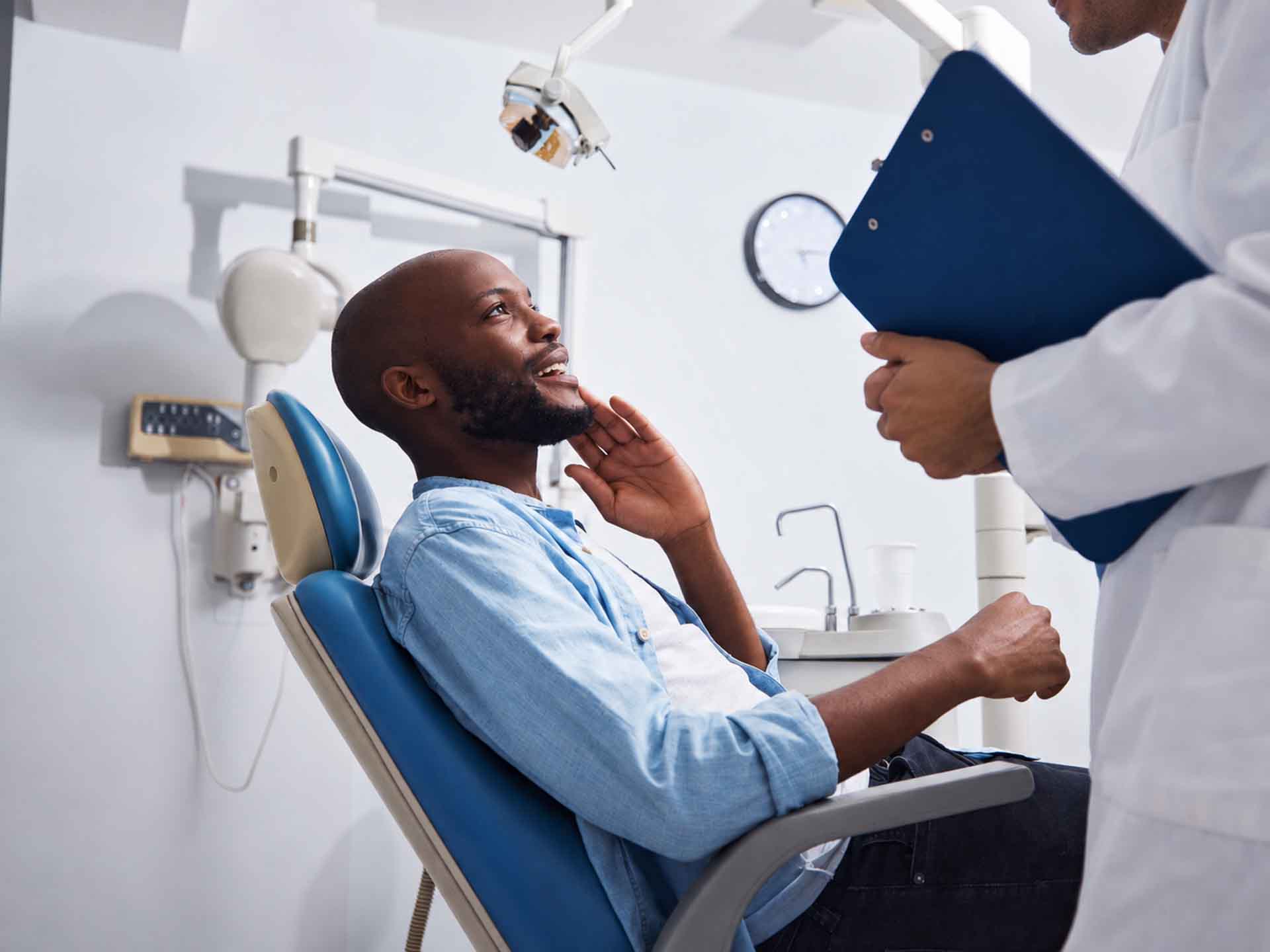 Patient discussing an urgent dental concern with a dentist in Grand Blanc, Michigan