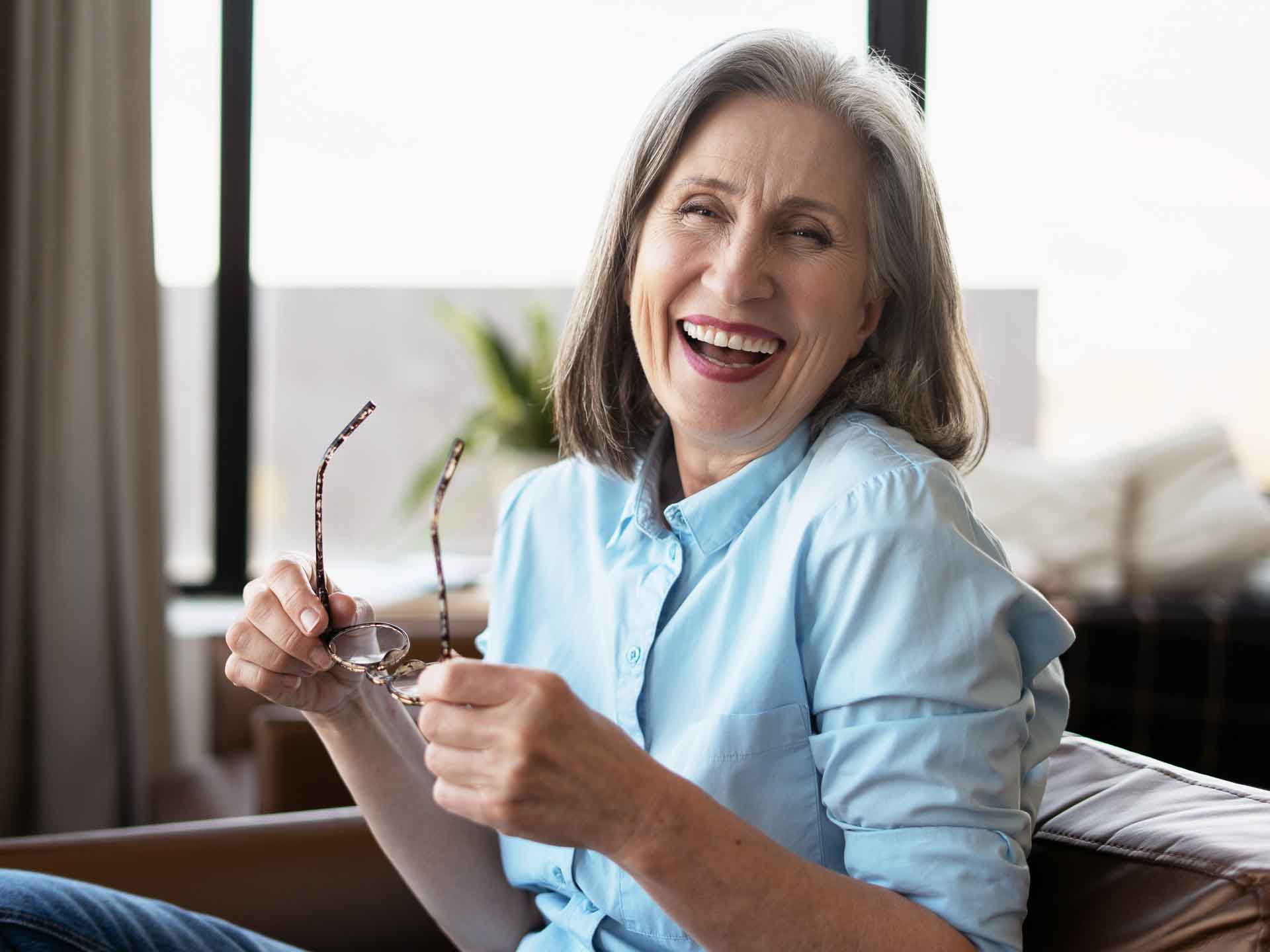Older woman smiling confidently representing healthy gums and periodontal care in Grand Blanc, Michigan