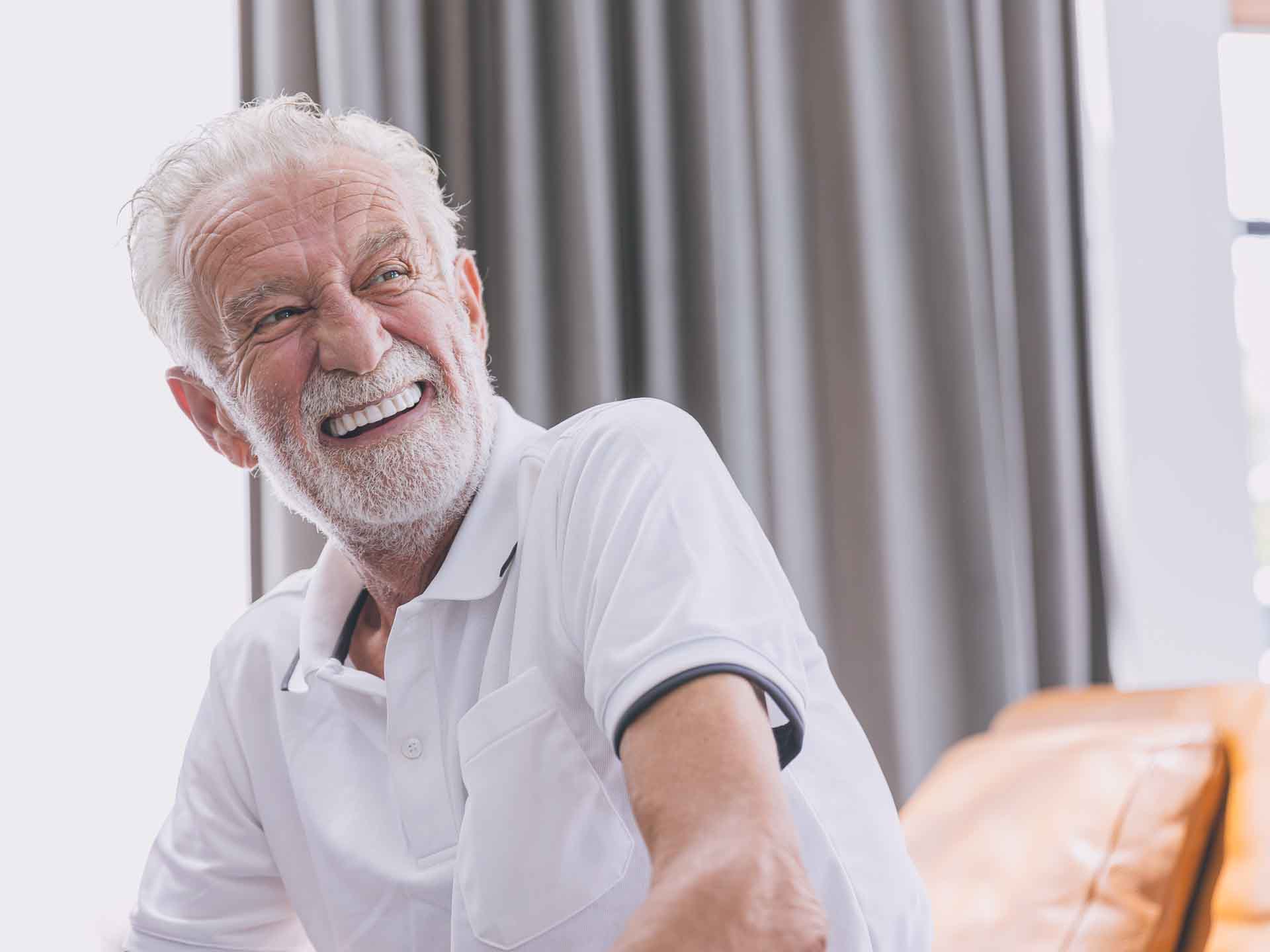 Older man smiling confidently representing restorative dentistry in Grand Blanc, Michigan