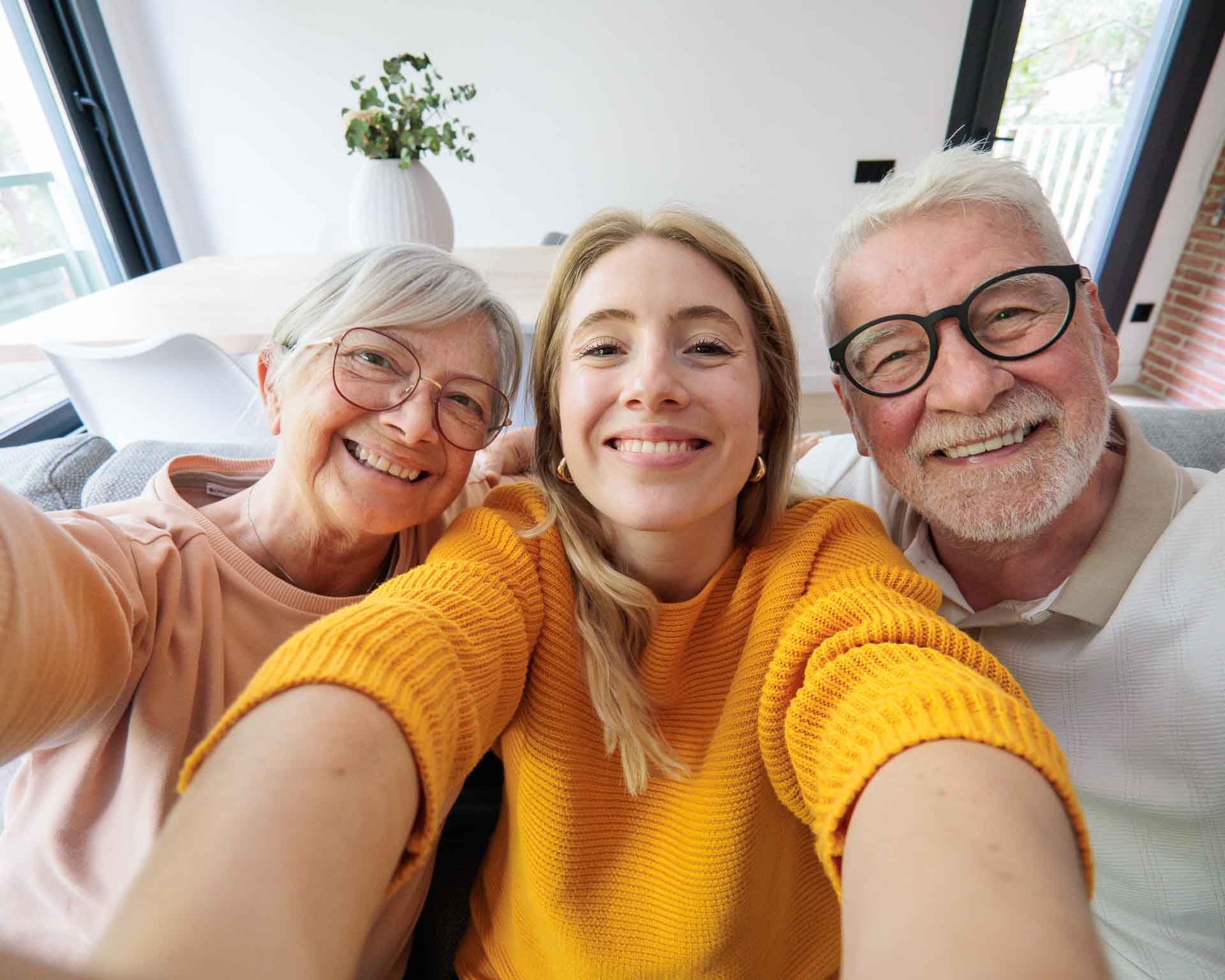 Family smiling for a selfie patients of Grand Blanc Dental Center in Grand Blanc Michigan